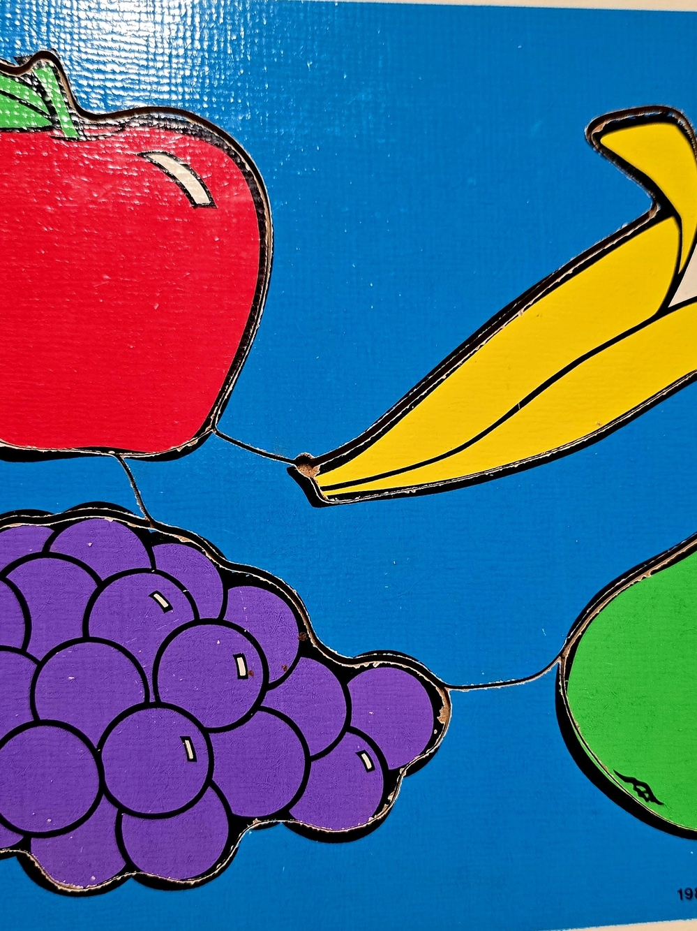 Colorful Fruit Puzzle Board.Blue Background, Red, Yellow, Purple, Green Pieces